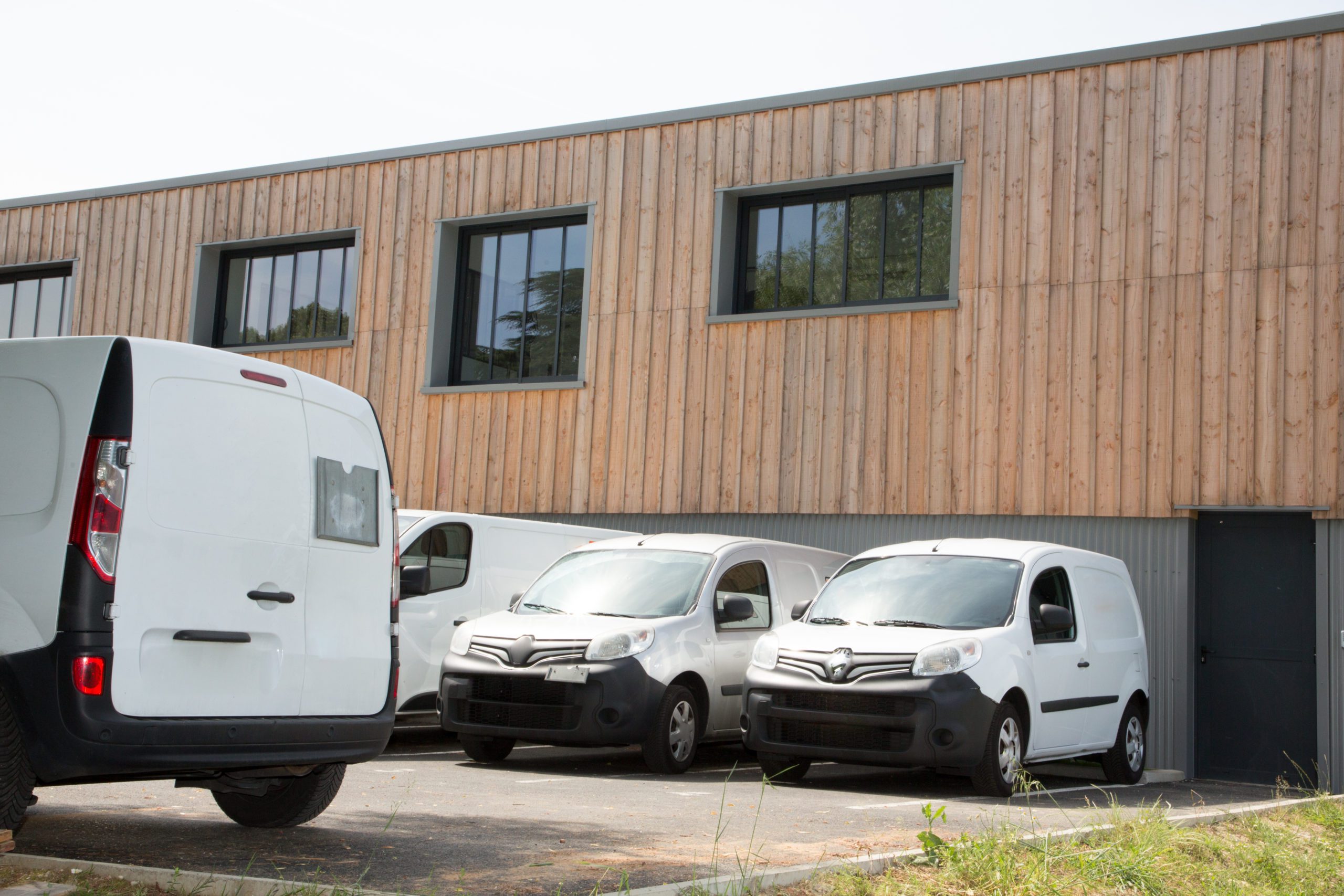 delivery van in row service trucks and cars front entrance