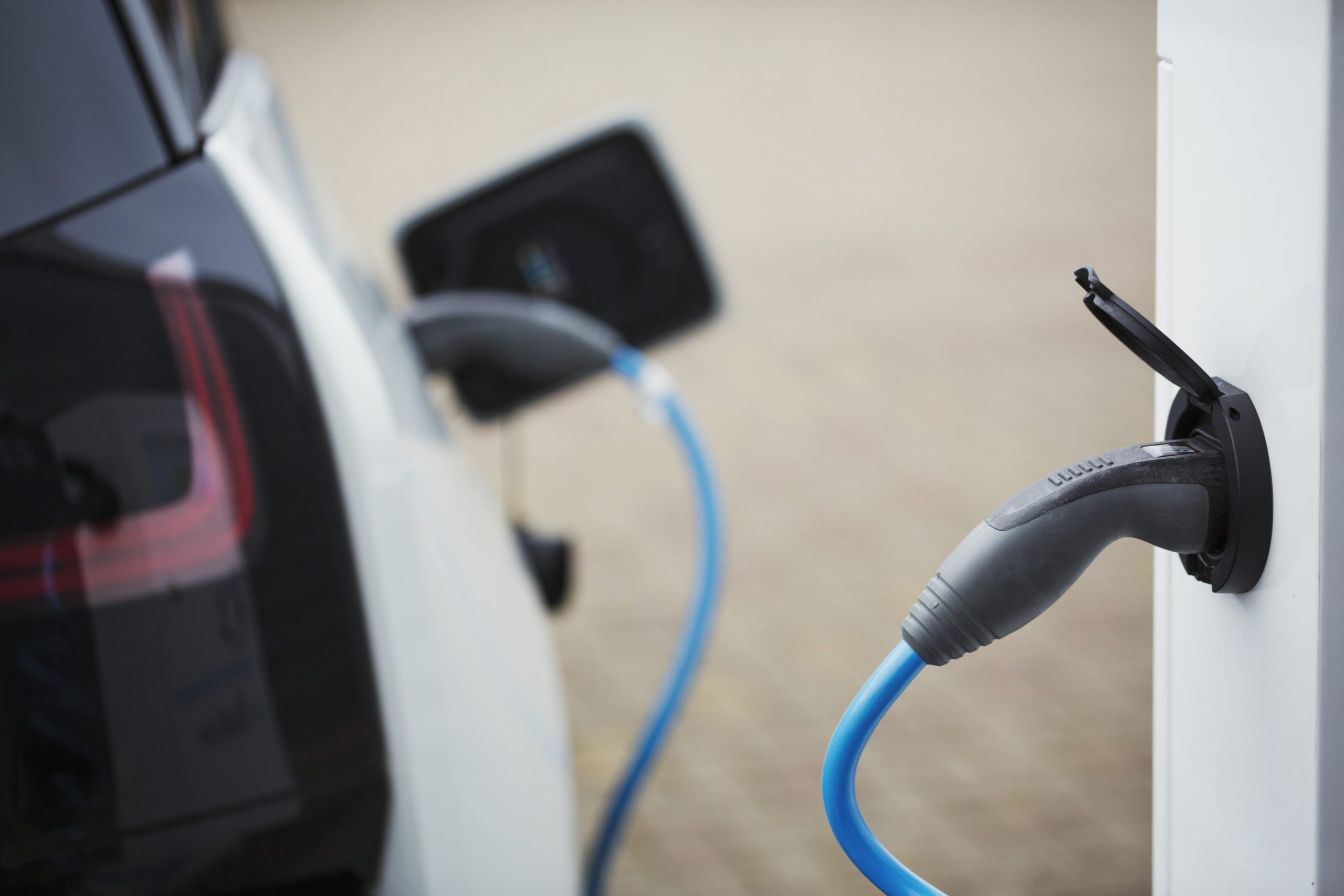 Electric car being charged with a cable connected to a wall socket.,Cycle Factory,England